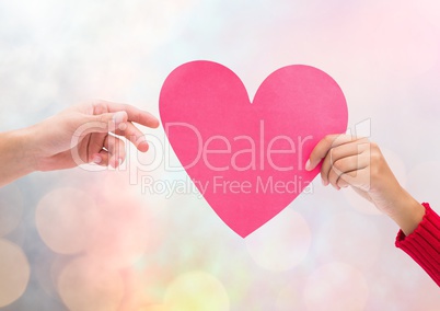 Hands holding heart with sparkling light bokeh background