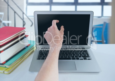 Student touching laptop in college