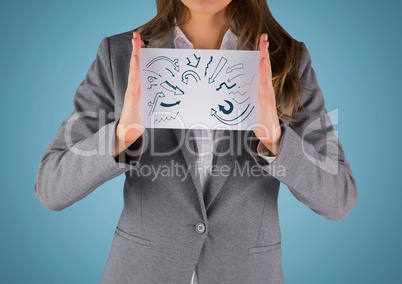 Business woman mid section with card showing blue arrow doodles against blue background