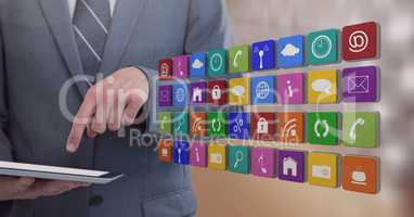 Businessman holding tablet with apps