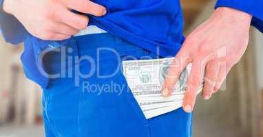 Construction Worker pocketing money notes in front of construction site