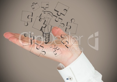 Hand with lightbulb graphic against brown background