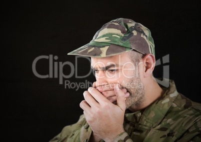 worried soldier foreground with cup. black background, light in his face.