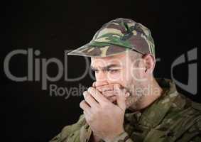 worried soldier foreground with cup. black background, light in his face.