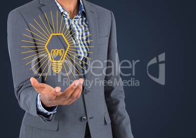 Business man mid section with yellow lightbulb graphic in hand against navy background