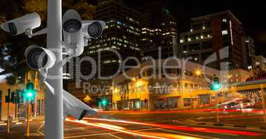 CCTV cameras against light trails in city at night