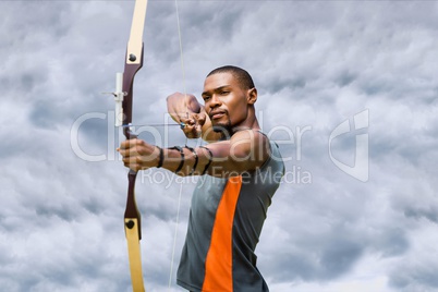 Archery player with a cloudy background