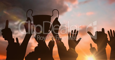 business hands with trophy shade and more hand shades. sunset