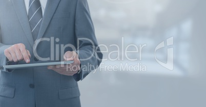 Businessman holding tablet in blue office