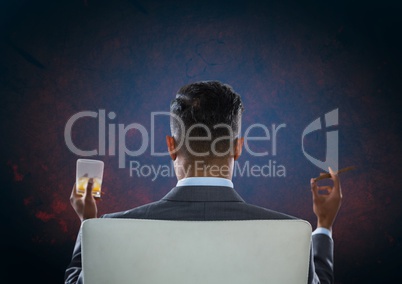 Businessman Back Sitting in Chair with drink glass and dark background