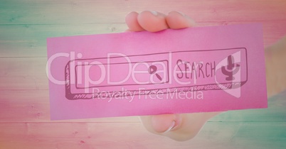 Hand with pink card showing pink search bar against wood panel