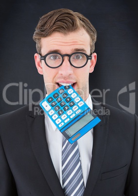 Man with calculator in mouth against navy chalkboard