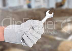 Hand with spanner on building site