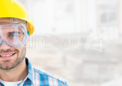 Construction Worker with eye protection goggles in front of construction site