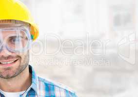 Construction Worker with eye protection goggles in front of construction site