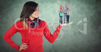 Digital image of beautiful woman with family on hand standing against green background