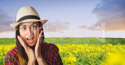 Surprised hipster standing on farm against sky