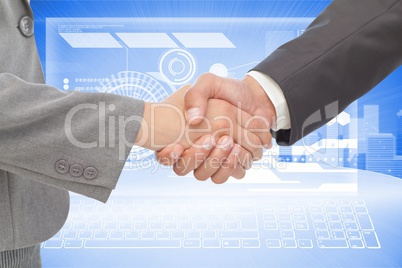 Business partners shaking their hands in front of digital background