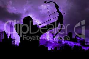 Shadow of archery player in front of purple sky background