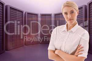 Business woman with arm crossed against the server room