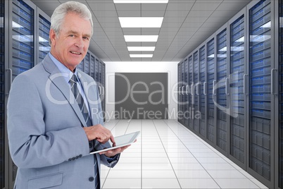 Businessman is holding a tablet computer against database background