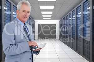 Businessman is holding a tablet computer against database background