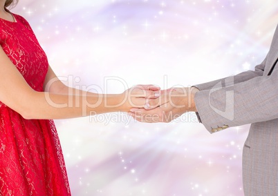 Couple holding Hands with sparkling light bokeh background