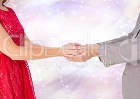 Couple holding Hands with sparkling light bokeh background