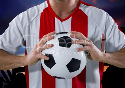 soccer player with ball in his hands, in front of the fans. purple sky background