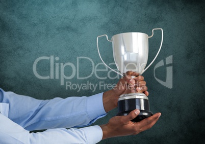 business hand with trophy, dark blue back