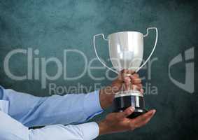 business hand with trophy, dark blue back