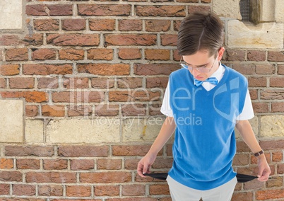 Sad young man with empty pocket and brick background