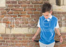 Sad young man with empty pocket and brick background