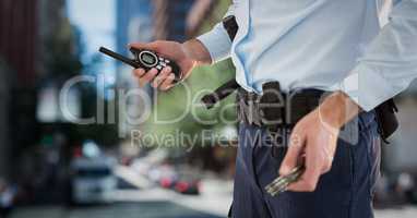 Security guard lower body with walkie talkie against blurry street