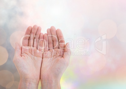 Hands open gentle with sparkling light bokeh background