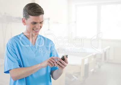 Doctor on mobile phone in bright hospital room