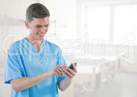 Doctor on mobile phone in bright hospital room