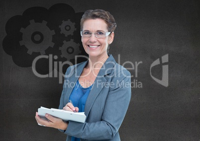 Business woman with clipboard against grey wall and cloud with gear graphic