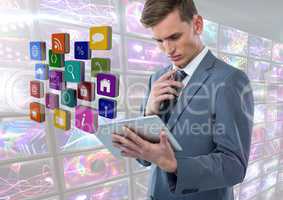 Businessman holding tablet with apps with colorful screens visuals
