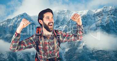 Happy rambler in front of snow-covered mountains background