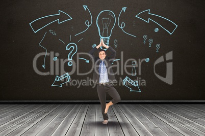 Businessman in yoga position in front of black board with a representation of idea