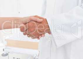 doctor and patient handshake in the hospital