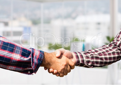 informal businessmen handshake in the office
