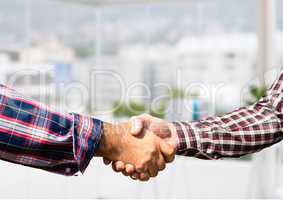 informal businessmen handshake in the office