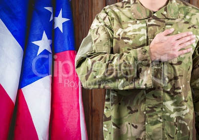 soldier with the hand on the hearth and the usa flag behind