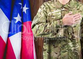 soldier with the hand on the hearth and the usa flag behind