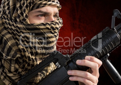 foreground of soldier side-face, with the face covered and weapon in his hands.red and black backgro
