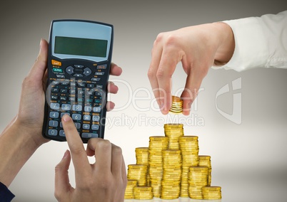 Cropped image of hands working on calculator and arranging gold coins