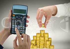 Cropped image of hands working on calculator and arranging gold coins