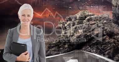 Digital image of businesswoman holding diary while standing on road against rock and graphs